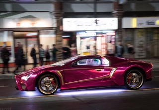 Custom stunt car mid-run at night